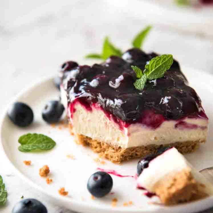 Easy and fast No Bake Blueberry Cheesecake Bars - creamy cheesecake with a gorgeous fresh blueberry sauce topping! recipetineats.com