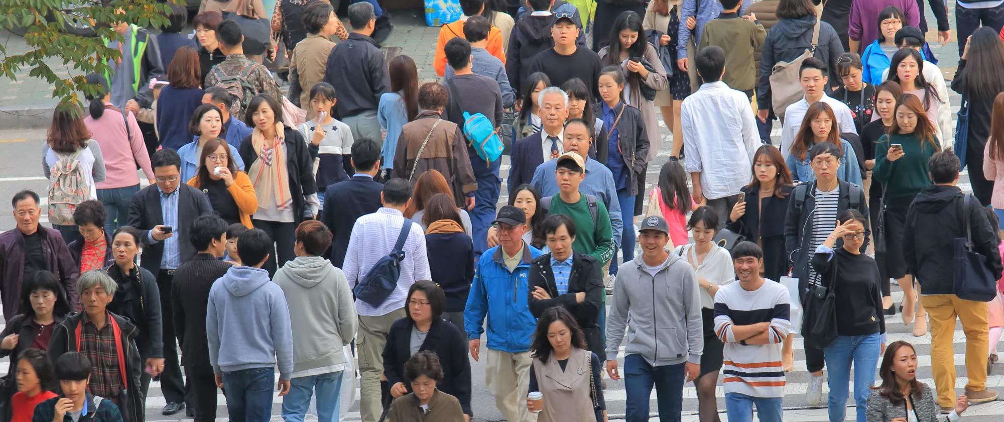 Crowd crossing a road