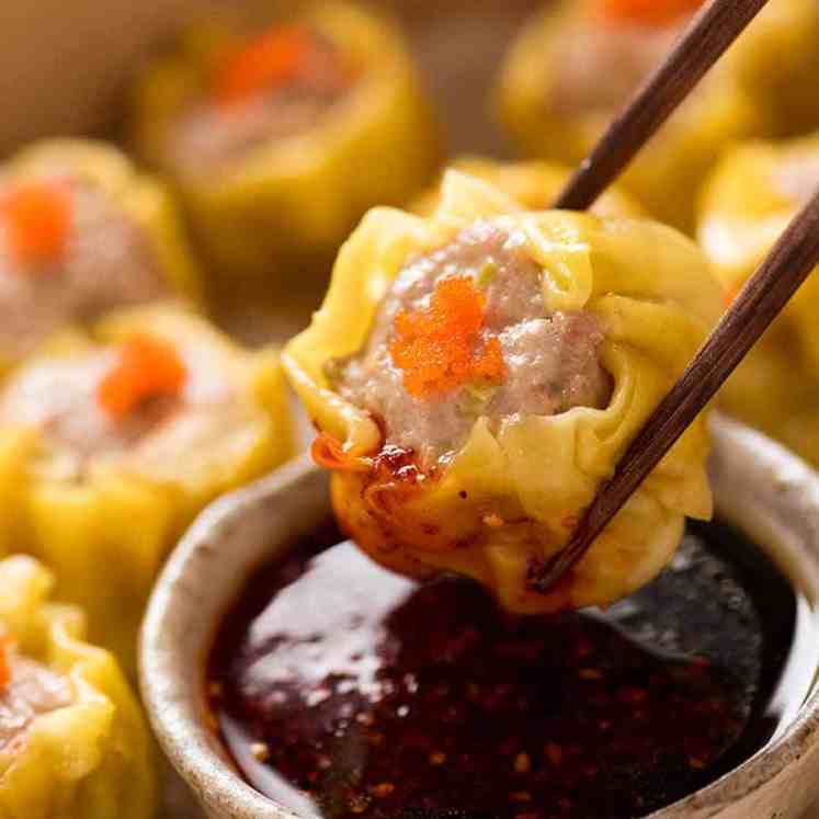 Close up of Siu Mai (Chinese steamed dumpling) dipped in sauce
