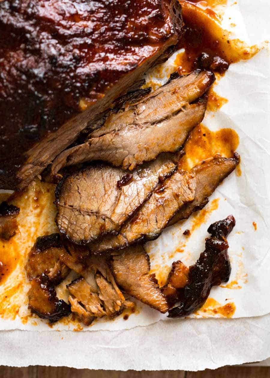 Beef brisket recipe - Close up of ultra tender Beef Brisket slices with BBQ Sauce.