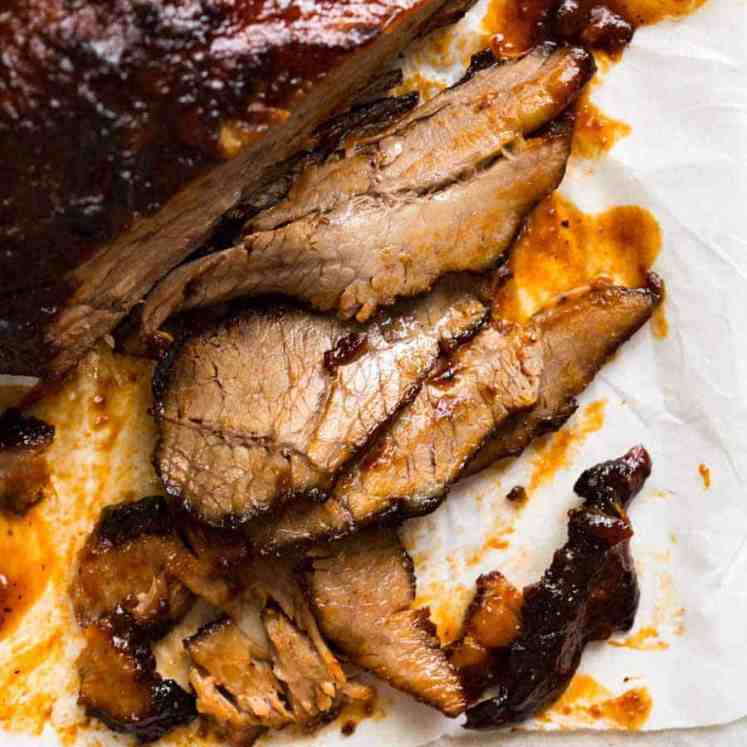Close up of ultra tender Beef Brisket slices with BBQ Sauce.
