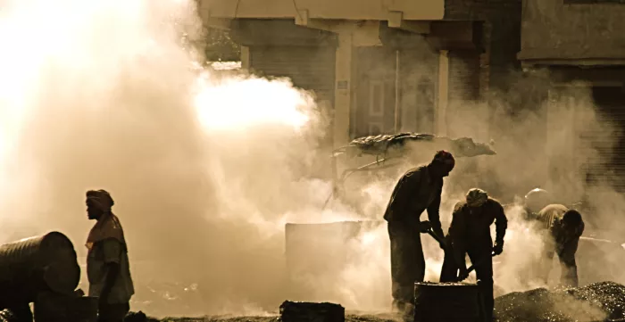 Workers in the heat and fumes of chemical products in the street