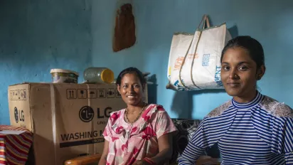 Mother and daughter sitting together in their home