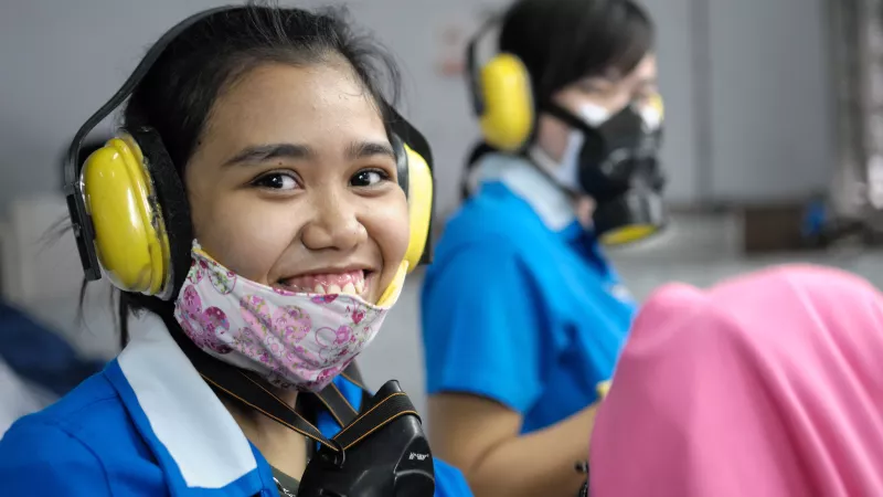 A smiling Indonesian female garment worker in Indonesia