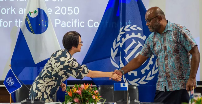 Chihoko Asada-Miyakawa, ILO Assistant Director-General and Regional Director for Asia and the Pacific and Esala Nayasi, Acting Secretary General of the Pacific Islands Forum Secretariat celebrate the signing