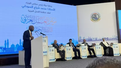 a man giving a speech on a stage