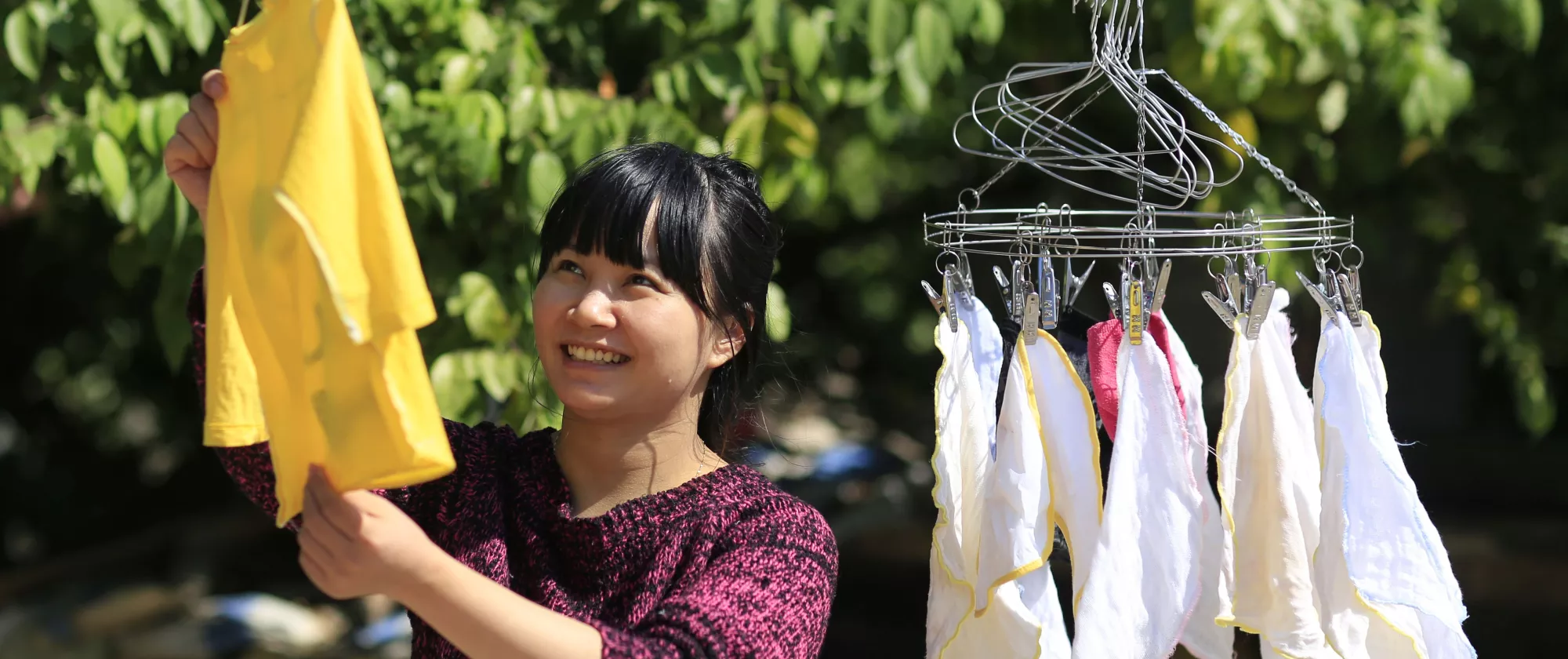 Domestic worker hanging clothes in Asia