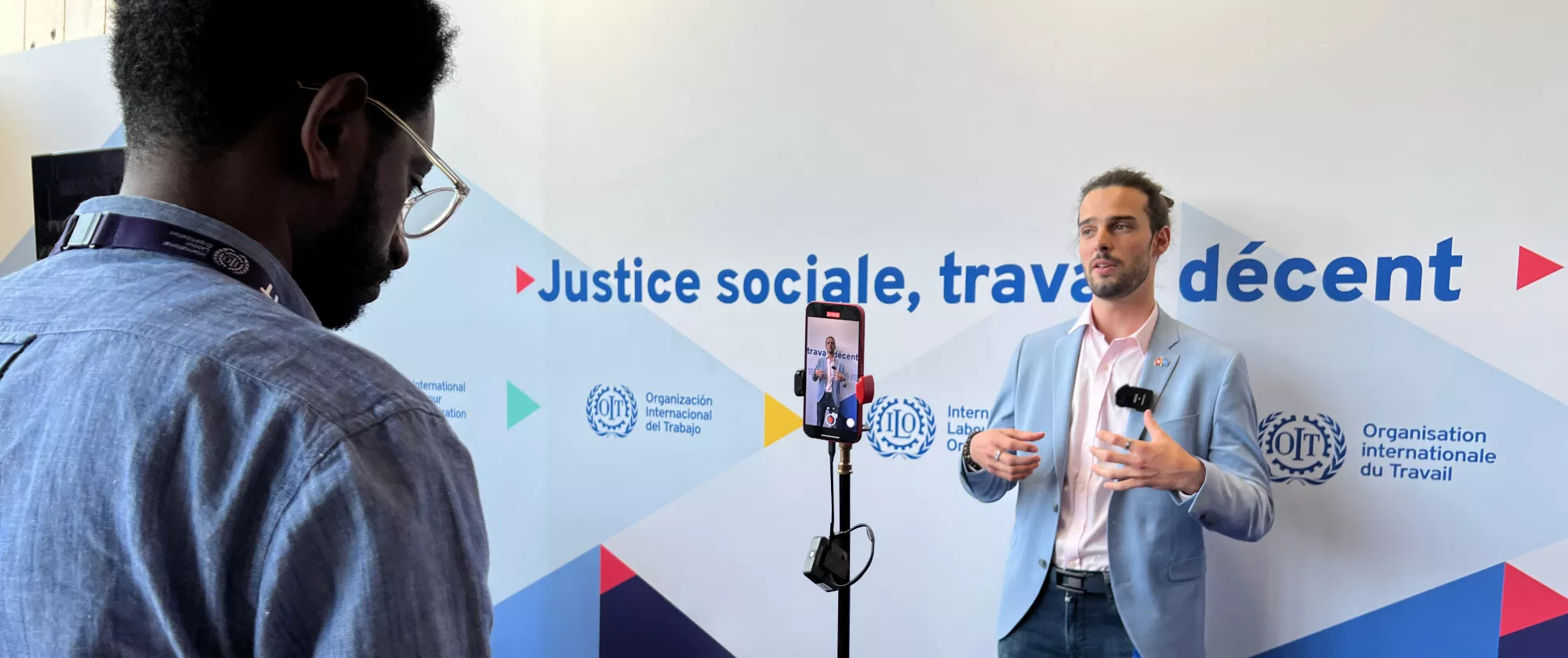 Person being interviewed in front of an ILO branded panel