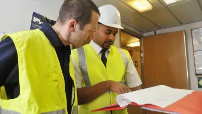 Officers and ship inspector checking the ship's compliance with safety standards