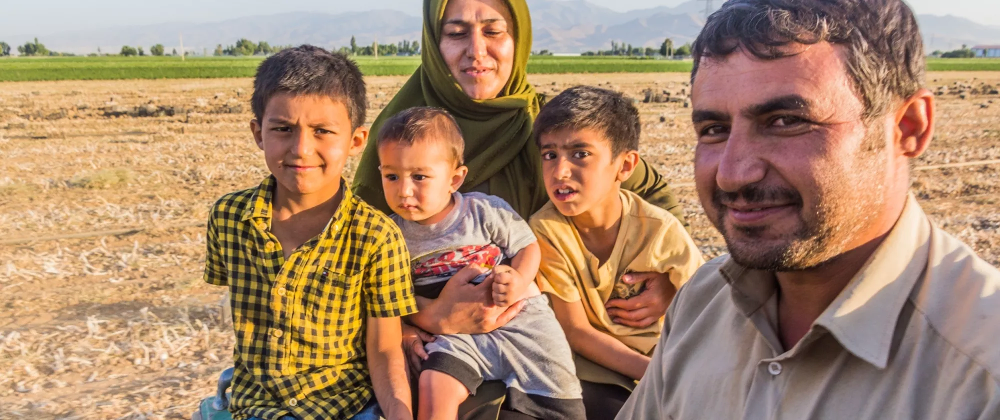 An Iranian family pose outside for a photo