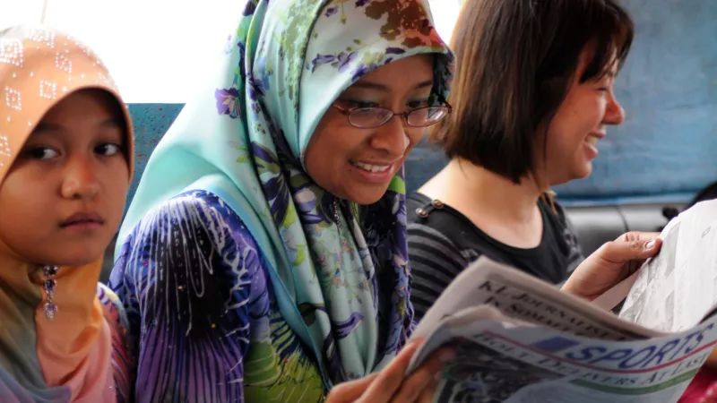 Brunei lady reading a newspaper