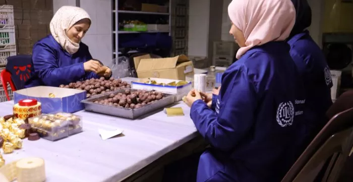 Two women working at the chocolate factory 